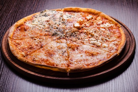 Pizza - four cheeses close up on the plateの写真素材