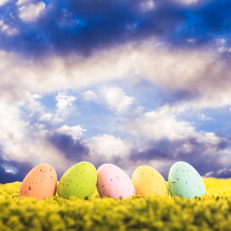 Easter eggs on the grass over blue sky