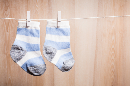 Baby boy socks attached to the ropeの写真素材