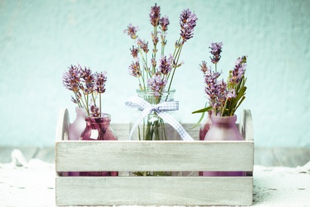 Lavender in bottles, decor provance style, wooden box on crochet tableclothの写真素材