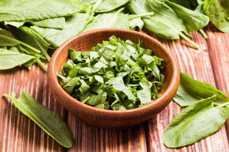 Fresh green sorrel in a wooden bowl