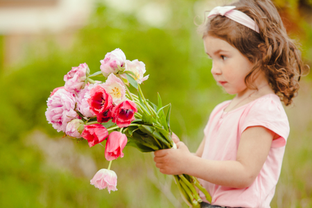 Girl with bouquet of pink flowers for mom on mother's day selebratinfの写真素材
