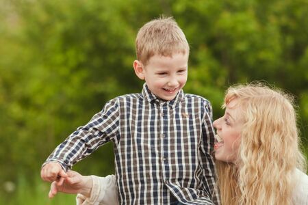 Portrait of a happy mother hugging her sonの写真素材