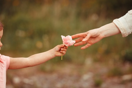Daughter gives a flower for mom, Mothers dayの写真素材