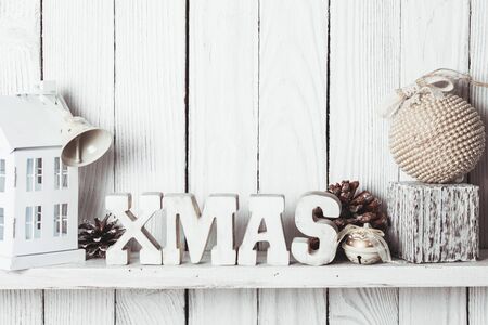 Christmas decor on the shelf - wooden letters XMAS over wooden wallの写真素材