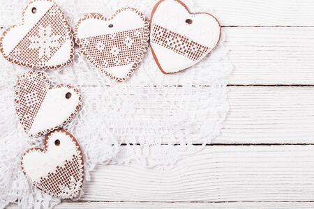 Gingerbread cookies in shape of heart with icing on a crochet doily, copy spaceの写真素材