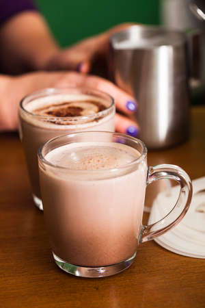 Glass with cocoa with milk on the table in cafeの写真素材
