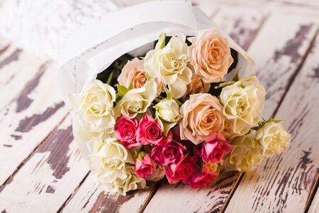 Luxury bouquet of roses lying on a wooden boardの写真素材