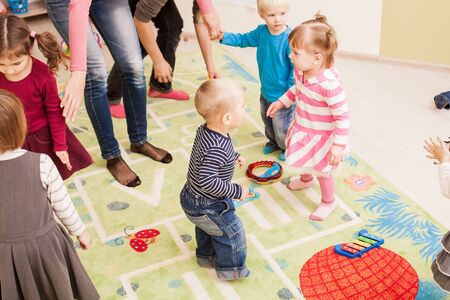 Group of little children dancing and listening the musicの写真素材