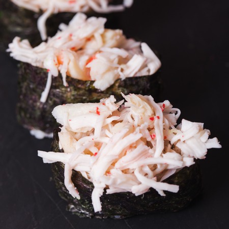 Close-up of Kani sushi with crab on a black slate backgroundの写真素材