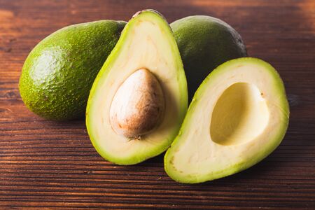 Close-up of an juicy organic avocado on wooden table