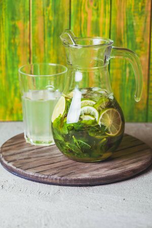 Lime and mint lemonade on a wooden rustic boardの写真素材