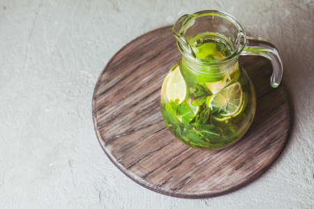 Lime and mint lemonade on a wooden rustic boardの写真素材