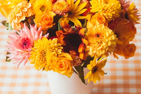 Vase with flowers on the table in a kitchen