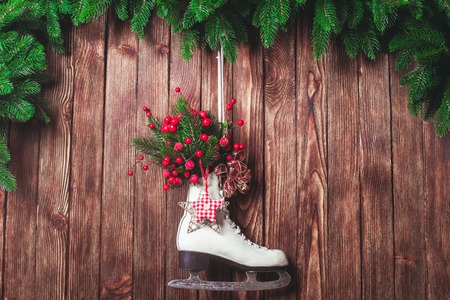 Christmas decorated skate on the wooden wallの写真素材