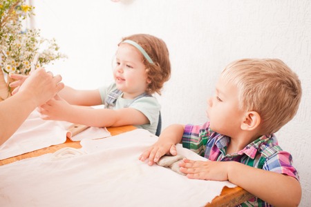 Little boy using a rolling pin that to roll modelling clayの写真素材