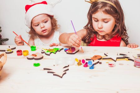 Two beautiful girls  painted wooden Christmas figurinesの写真素材