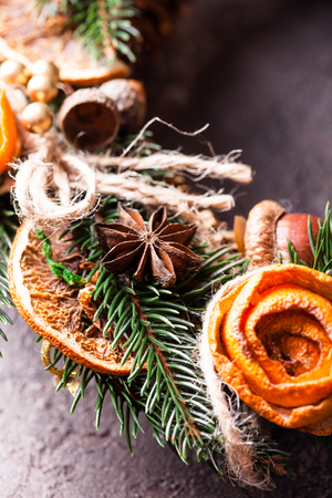 Christmas aromatic eco wreath with dry orange and anise stars, decorated tangerine peel roses, closeup detailsの写真素材
