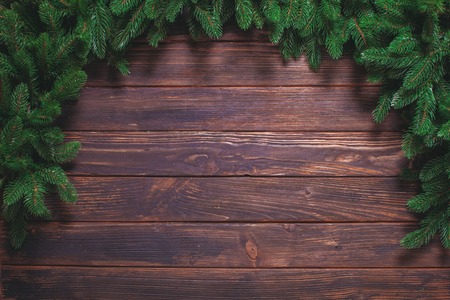 Christmas or fir backgrounds. Wooden background with fir-tree on the edge.の写真素材