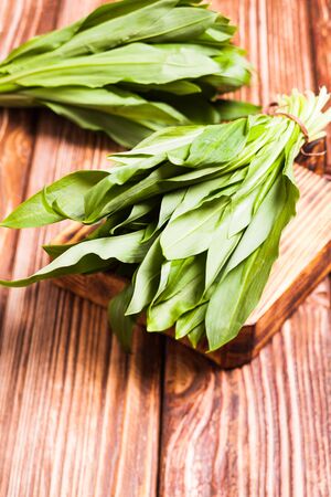 A bunch of wild garlic  on wooden board