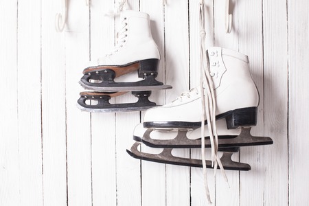 Two pairs of skates hanging on the hook. Family skating conceptの写真素材