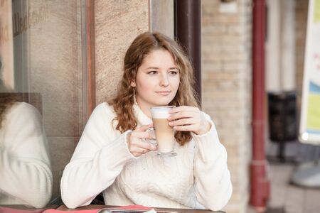 Latte in the handの写真素材