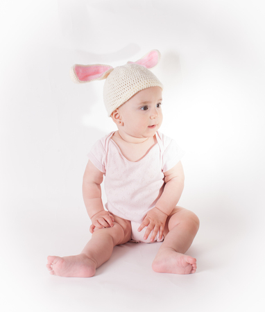 Baby girl in a rabbit hatの写真素材