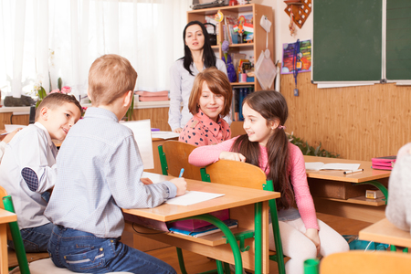 School girl explaining her classmateの写真素材