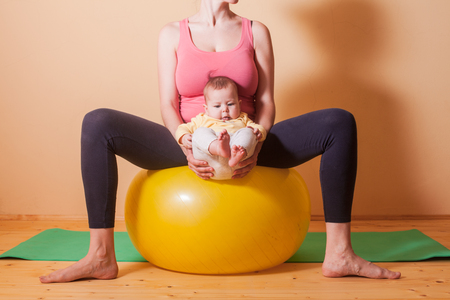 Baby exercises on the fitballの写真素材