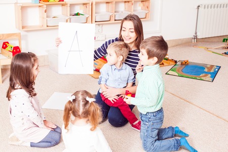 Teacher teaches preschoolersの写真素材