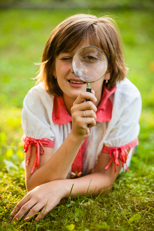 Teenage with magnifying glassの写真素材