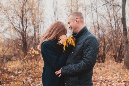 Happy couple in the autumn parkの写真素材