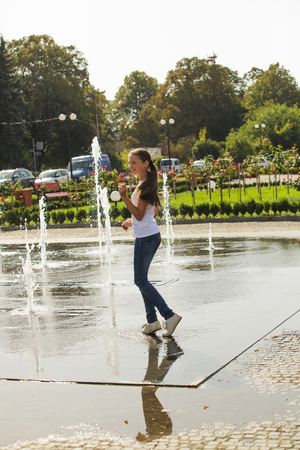 Two happy kids playing in fountainの写真素材
