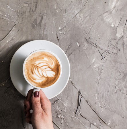 Cup of cappuccino with figure creamの写真素材