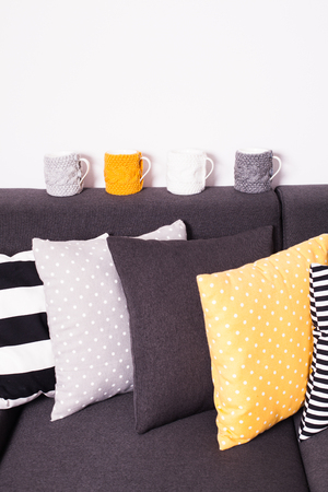Gray sofa with many colorful pillows on itの写真素材