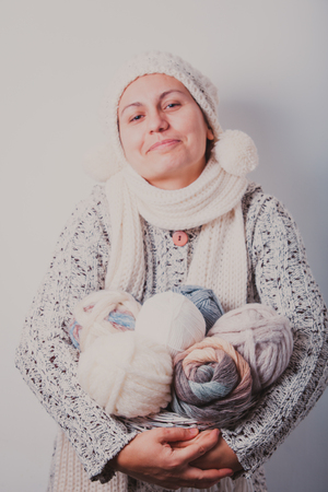 Woman with basket of balls of woolen yarnの写真素材