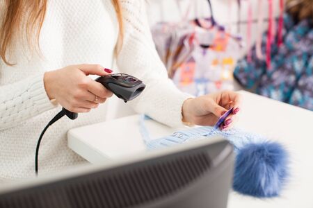 Seller holding barcode scanner in a hand