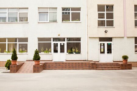 Facade of the school building with the flag