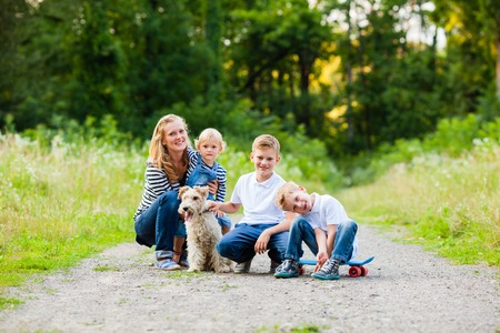 Family with fox terrier dogの写真素材