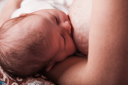 Mother breastfeeding her newborn babyの写真素材