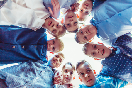 Bottom view of young boys faces in the round. Schoolmates on the breakの写真素材