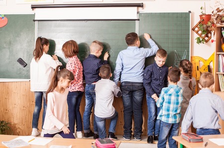 classmates draw on a board during the breakの写真素材
