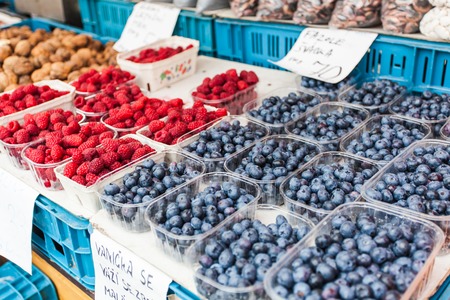 Plastic trays with fresh blueberries and raspberries.の写真素材
