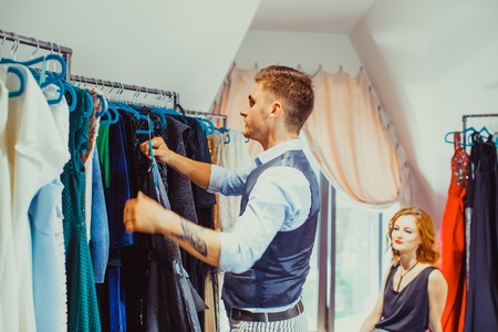Young attractive man working as a buyer for a women