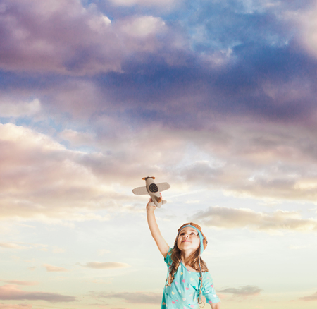 Little boy flying a toy planeの写真素材