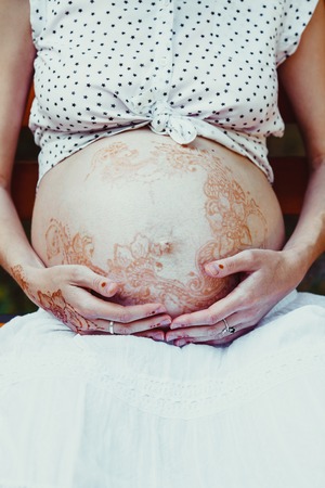 Close view of womans pregnant bellyの写真素材