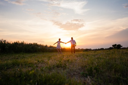 Rustic wedding couple at sunset in the summer outdoorsの写真素材