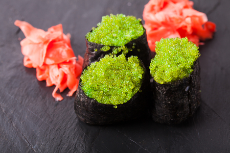 Tobiko green sushi and red marinated ginger slicesの写真素材