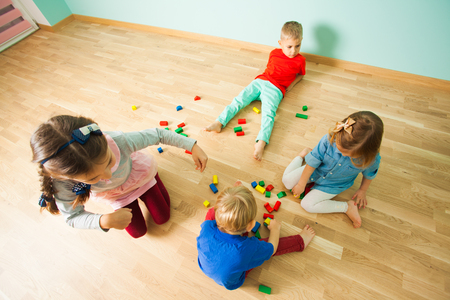 Four kids spending their leisure time at homeの写真素材