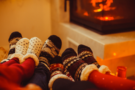 Big family is warming near the fireplaceの写真素材